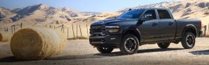 Black Ram pickup truck on a rural road.